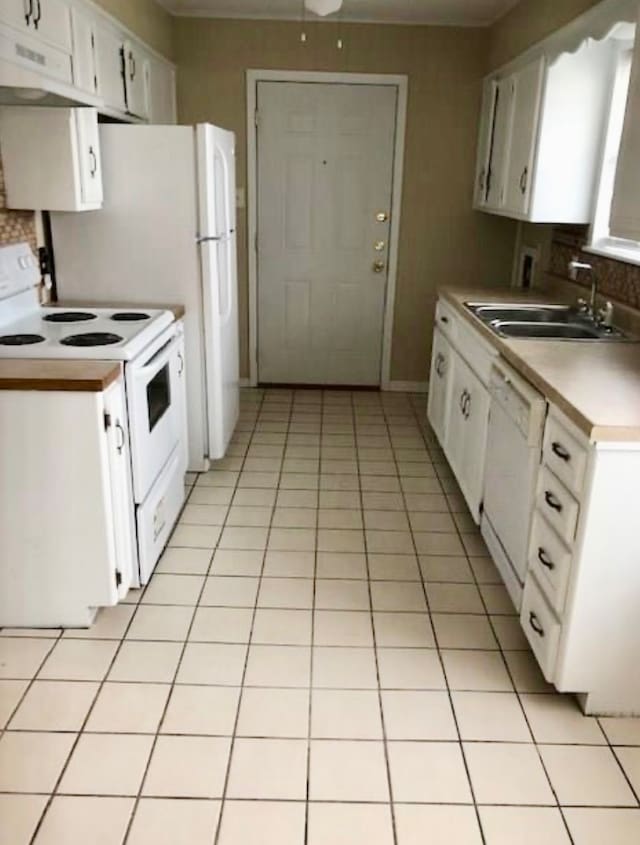 kitchen with light tile patterned flooring, white appliances, white cabinetry, and sink