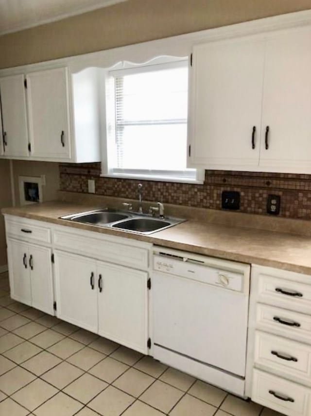 kitchen with backsplash, dishwasher, white cabinets, and sink