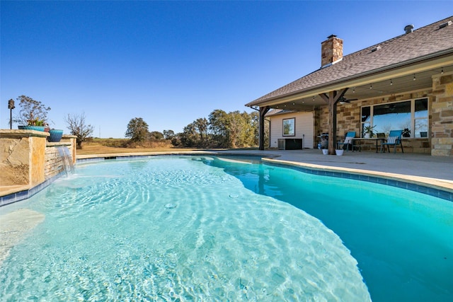 view of pool featuring a patio area, ceiling fan, and pool water feature