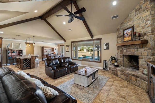 living room featuring ceiling fan with notable chandelier, high vaulted ceiling, beam ceiling, and a fireplace