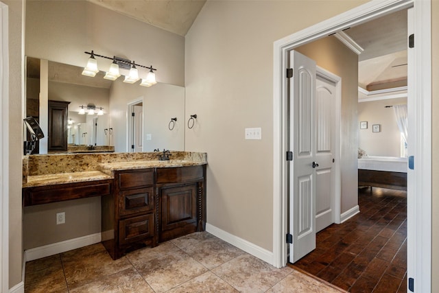 bathroom with vanity and ornamental molding