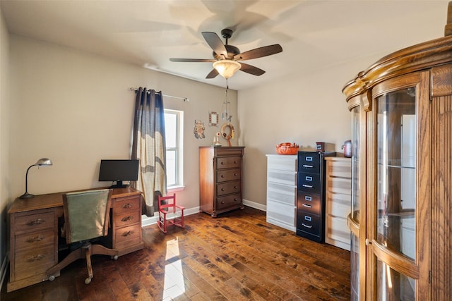 home office with ceiling fan and dark hardwood / wood-style flooring