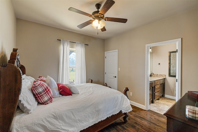 bedroom featuring ceiling fan, ensuite bathroom, and dark hardwood / wood-style flooring