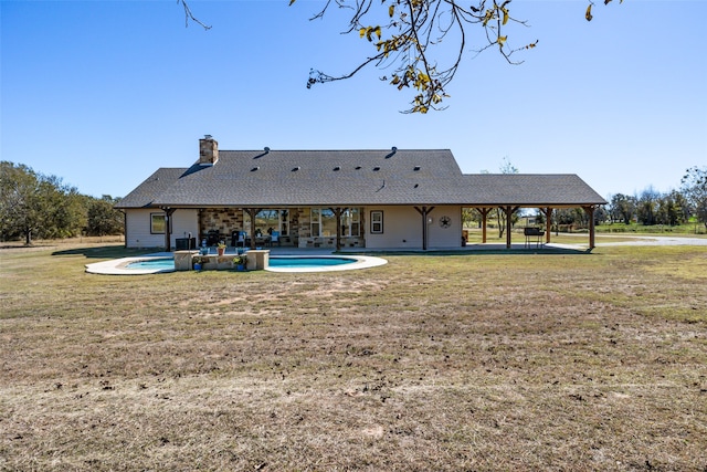 back of property with a yard and a patio