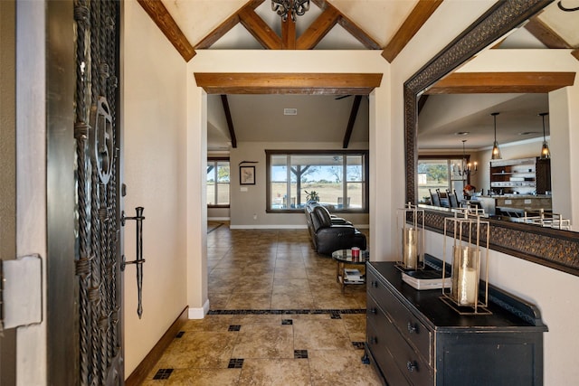 entrance foyer featuring vaulted ceiling with beams and an inviting chandelier