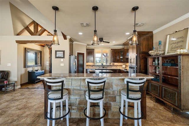 kitchen featuring a large island, hanging light fixtures, and appliances with stainless steel finishes