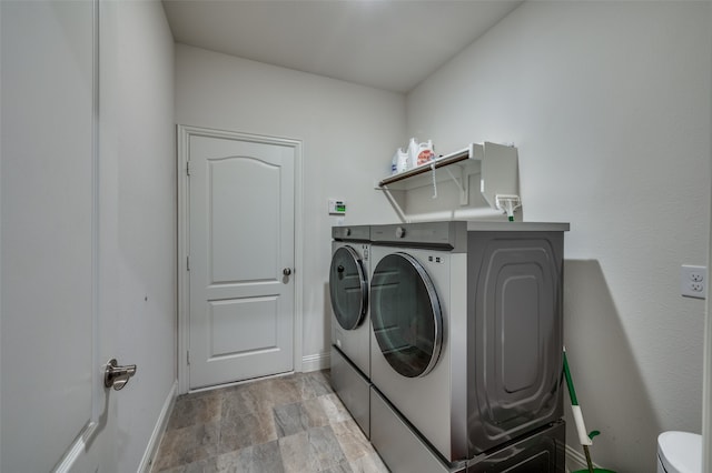 laundry room featuring washer and clothes dryer and light wood-type flooring