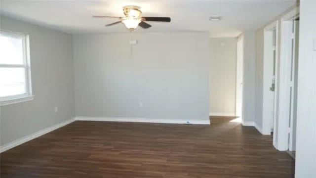 spare room featuring ceiling fan and dark hardwood / wood-style floors