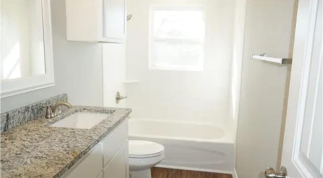 full bathroom featuring vanity, toilet, and bathtub / shower combination