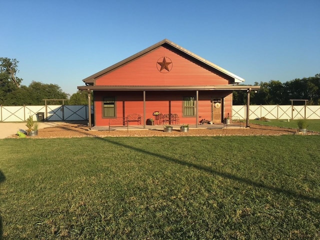 back of house featuring a patio area and a yard