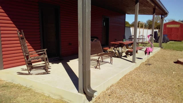 view of patio featuring a storage unit