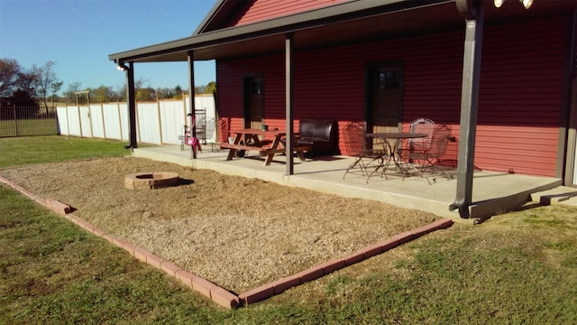 exterior space featuring a patio area, a yard, and a fire pit