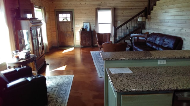 foyer featuring wood walls and dark hardwood / wood-style flooring