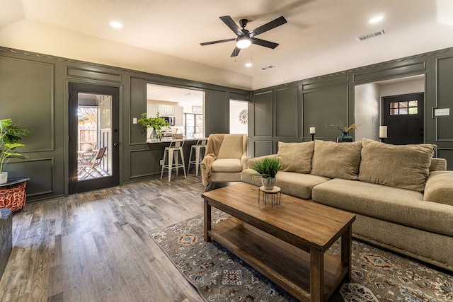 living room featuring hardwood / wood-style flooring and ceiling fan