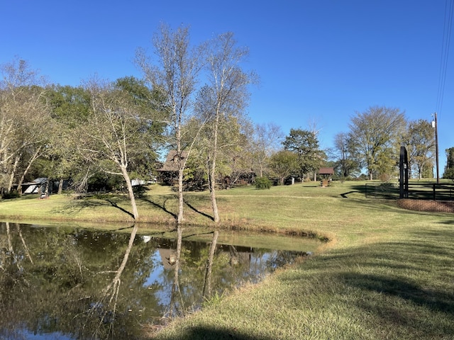 exterior space featuring a lawn and a water view