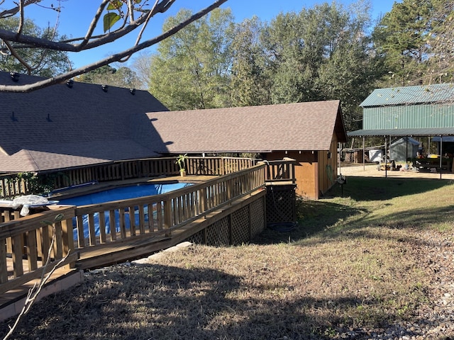 view of pool featuring a lawn and a deck