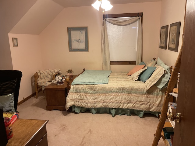 bedroom with light colored carpet and vaulted ceiling