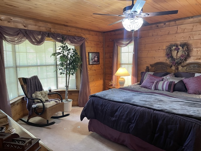 bedroom with ceiling fan, wooden walls, and wood ceiling