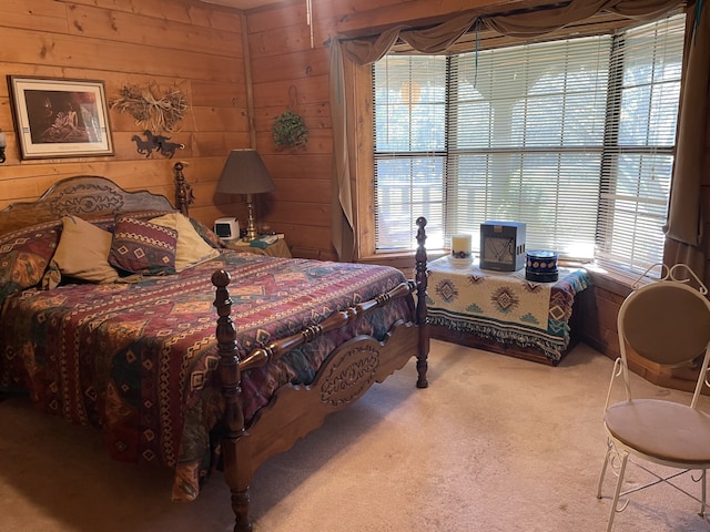 carpeted bedroom with wooden walls and multiple windows