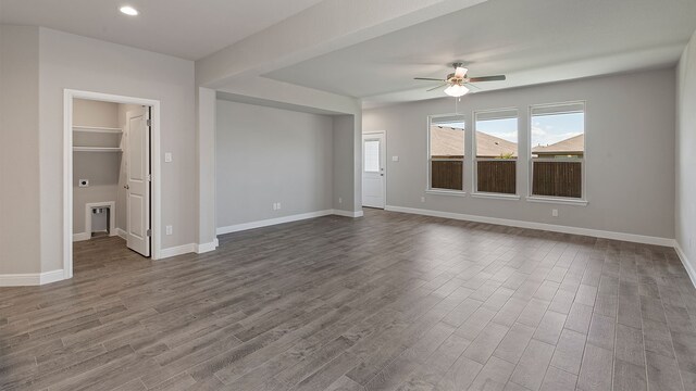 unfurnished room with dark hardwood / wood-style flooring and ceiling fan