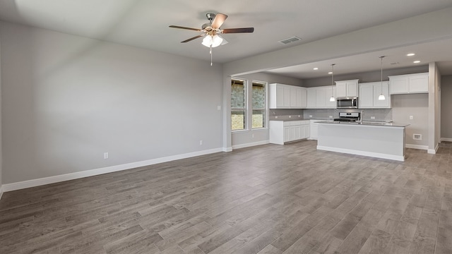 unfurnished living room featuring light wood-type flooring and ceiling fan