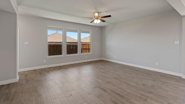 unfurnished room featuring ceiling fan and hardwood / wood-style flooring