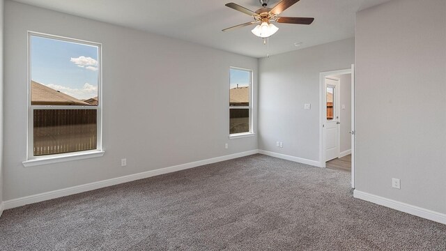 carpeted empty room featuring ceiling fan