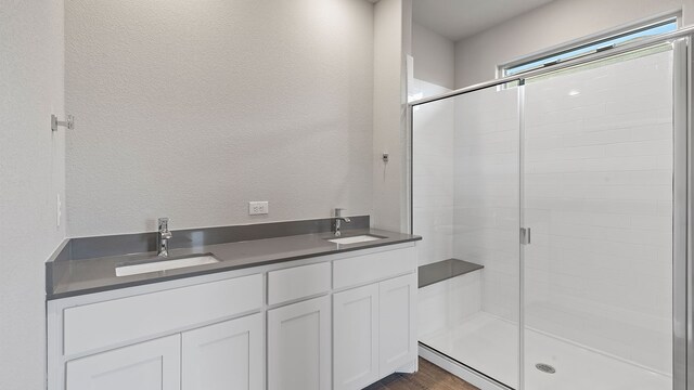 bathroom featuring vanity, hardwood / wood-style flooring, and an enclosed shower