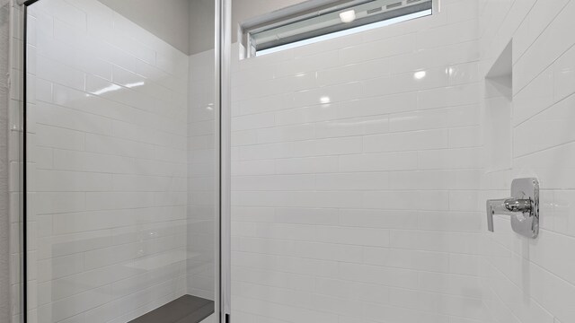 bathroom with a tile shower