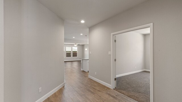 corridor with light hardwood / wood-style flooring