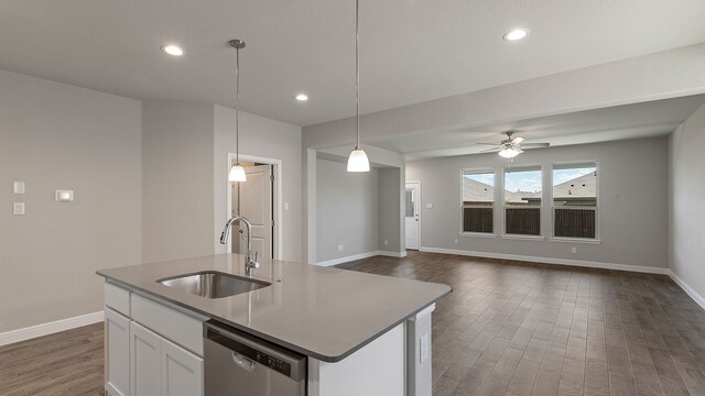 kitchen with white cabinetry, sink, dishwasher, hanging light fixtures, and a kitchen island with sink