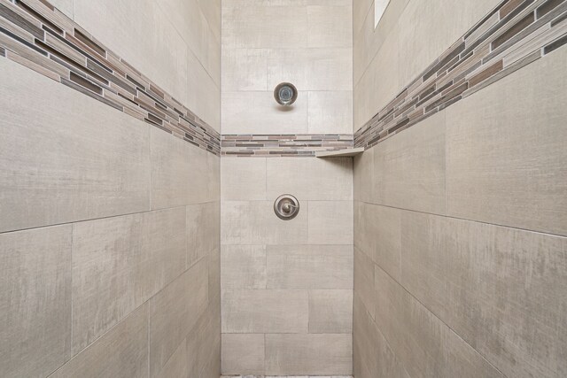 bathroom with tiled shower