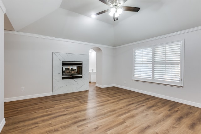 unfurnished living room with hardwood / wood-style floors, vaulted ceiling, ceiling fan, and crown molding