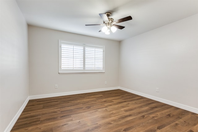 empty room featuring ceiling fan and dark wood-type flooring