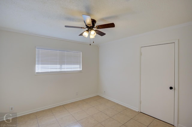 tiled empty room with crown molding, ceiling fan, and a textured ceiling