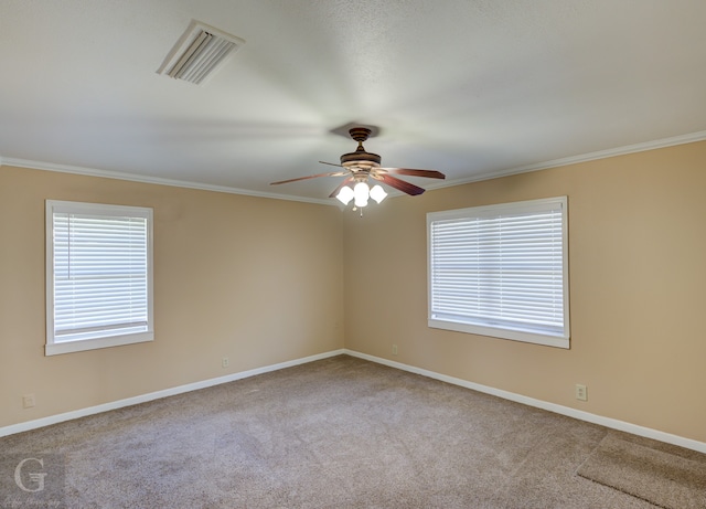 carpeted empty room featuring crown molding and ceiling fan