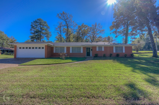 ranch-style house with a garage and a front lawn