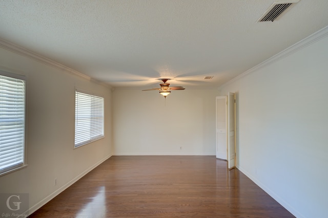 empty room featuring ceiling fan, ornamental molding, dark wood-type flooring, and a textured ceiling