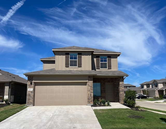 view of front of property with a garage and a front lawn