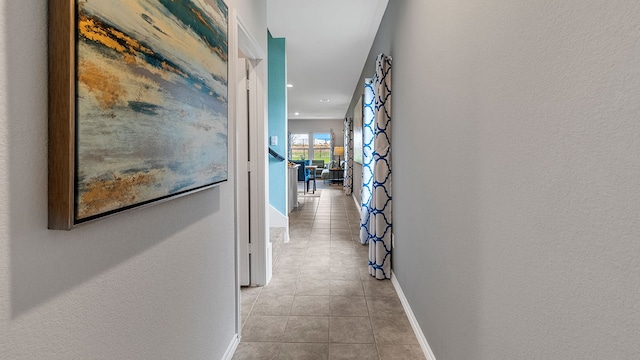 corridor with light tile patterned floors