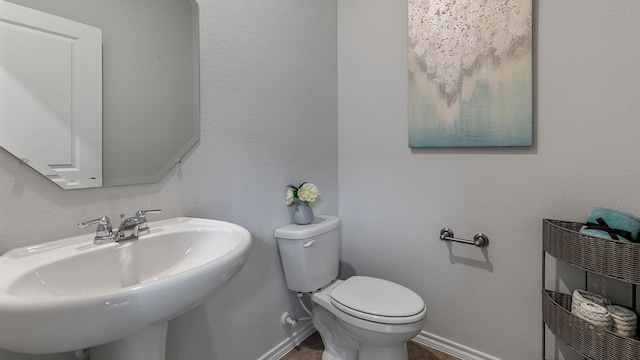 bathroom featuring sink and toilet