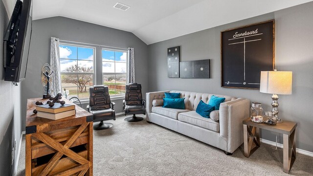 living room featuring carpet floors and vaulted ceiling