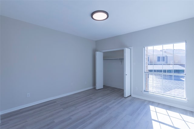 unfurnished bedroom featuring hardwood / wood-style flooring and a closet