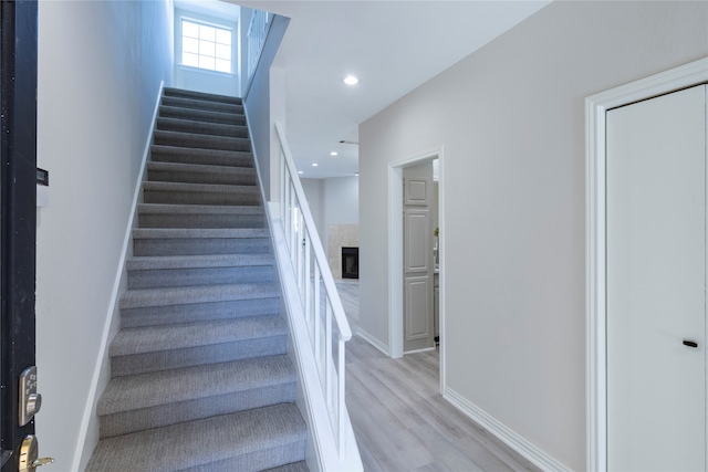 stairs with hardwood / wood-style floors