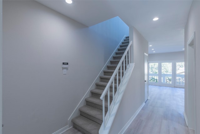 stairs with hardwood / wood-style floors