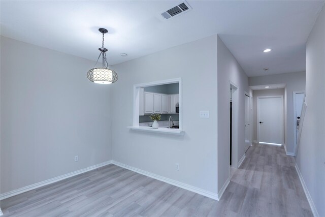 interior space with light hardwood / wood-style flooring and sink