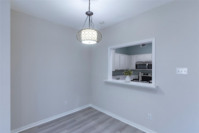 unfurnished dining area featuring light hardwood / wood-style floors