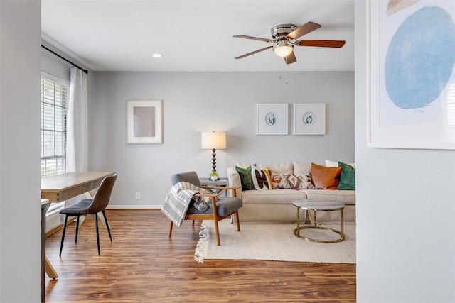 living room with hardwood / wood-style floors and ceiling fan