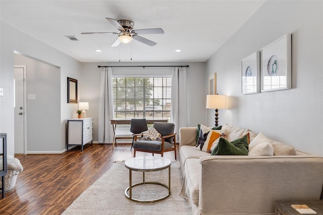 living room featuring ceiling fan and dark hardwood / wood-style floors