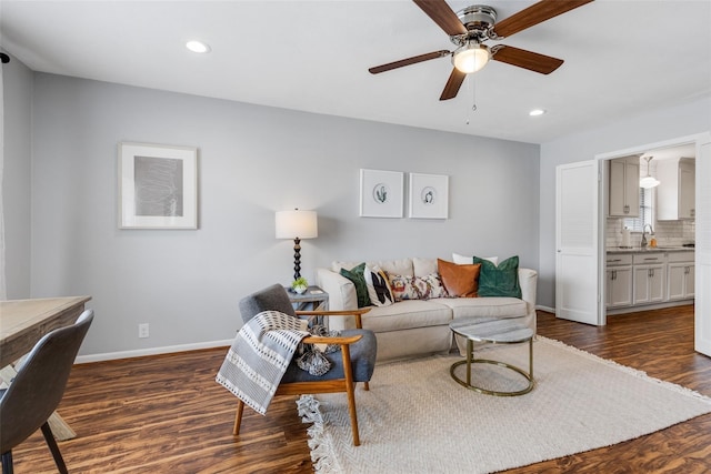 living room with ceiling fan and dark wood-type flooring